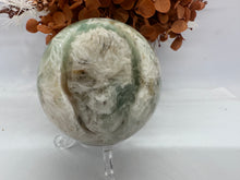 Load image into Gallery viewer, Skull Feather Fluorite Sphere
